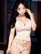 A woman in a white lingerie posing for a picture.